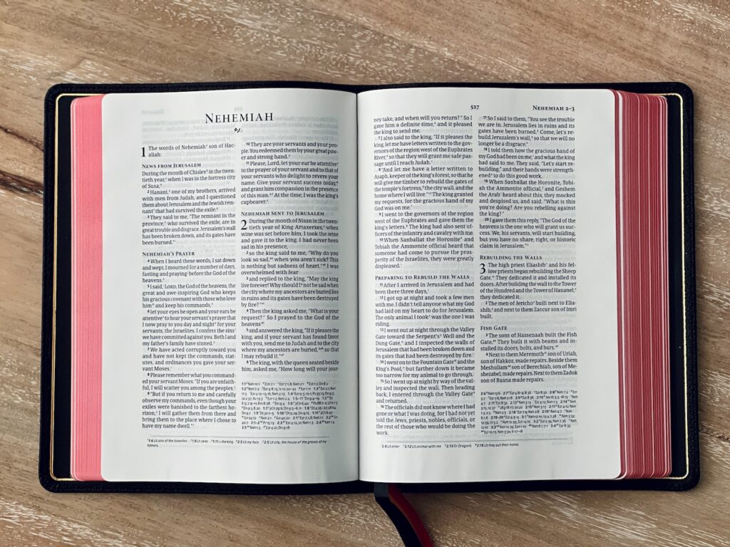 an open book sitting on top of a wooden table